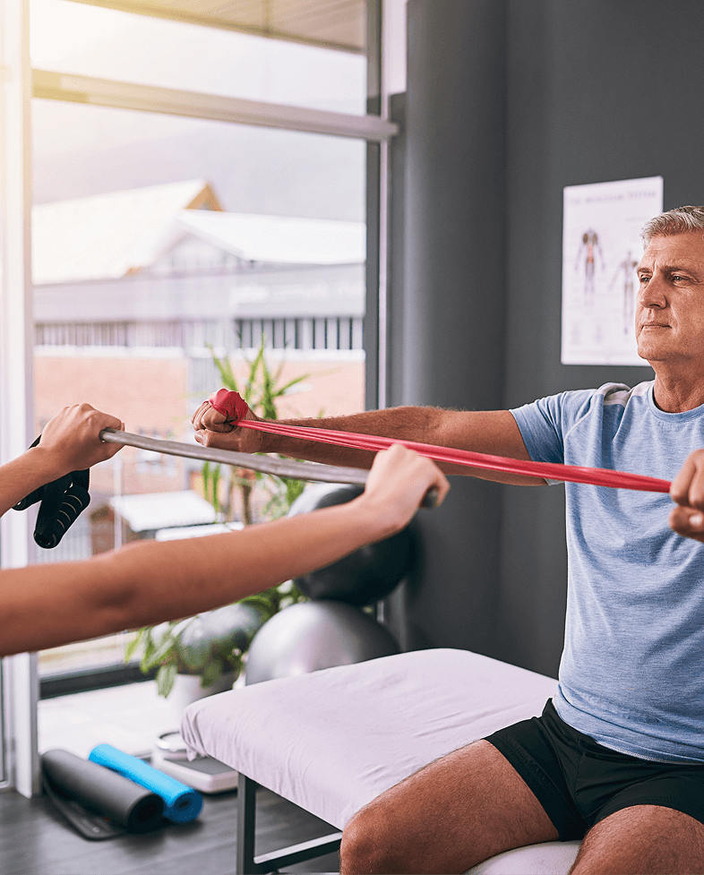 Patient performing resistance band shoulder rehabilitation exercise with physical therapist at Fort Lee PT NJ