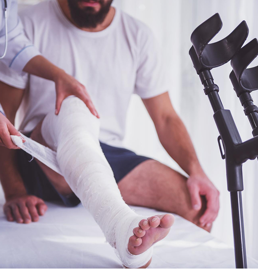 Physical therapist treating leg cast injury during rehabilitation session at Fort Lee PT in Fort Lee NJ